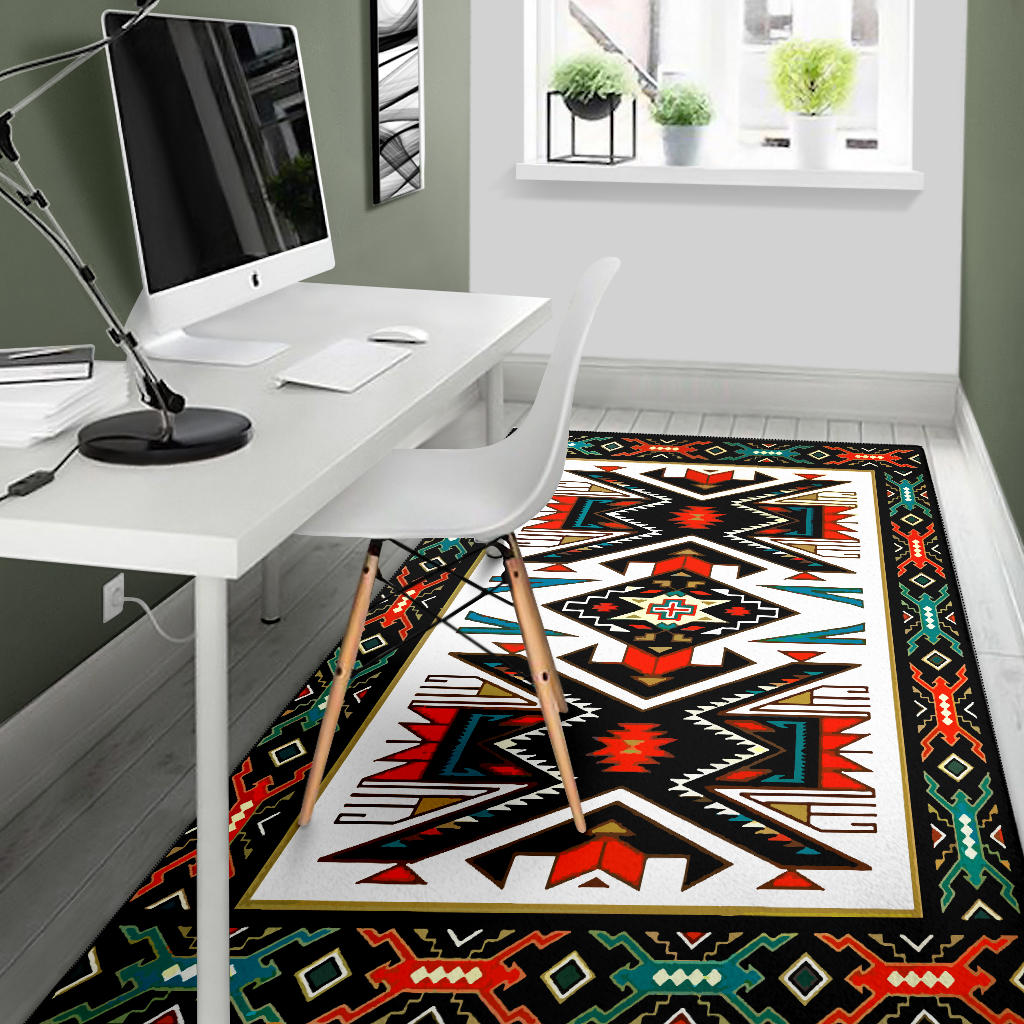 Tribal geometric area rug, black border with red, green, and blue accents, under desk