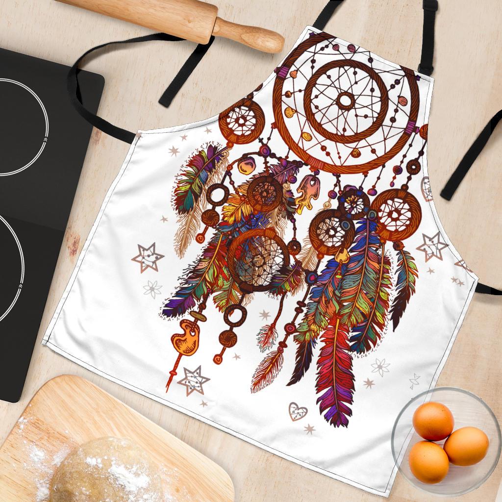 White apron flat lay showing multicolor dreamcatcher circle, feathers, stars and keys