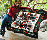 Native American-style premium quilt draped outdoors, black border with multicolor geometric center