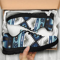 Blue and white geometric patterned sneakers in box with black laces and black rubber sole