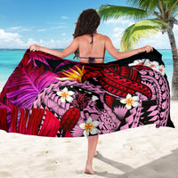 Hawaiian sarong spread out, red/purple tropical print with banana leaf colors and turtle design
