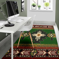 Green area rug featuring multicolor geometric starburst and red edge border pattern
