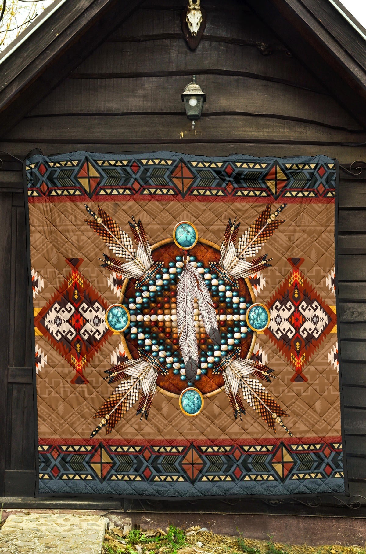 Brown Native-inspired quilt with central feather design, turquoise medallion circles, dark trim