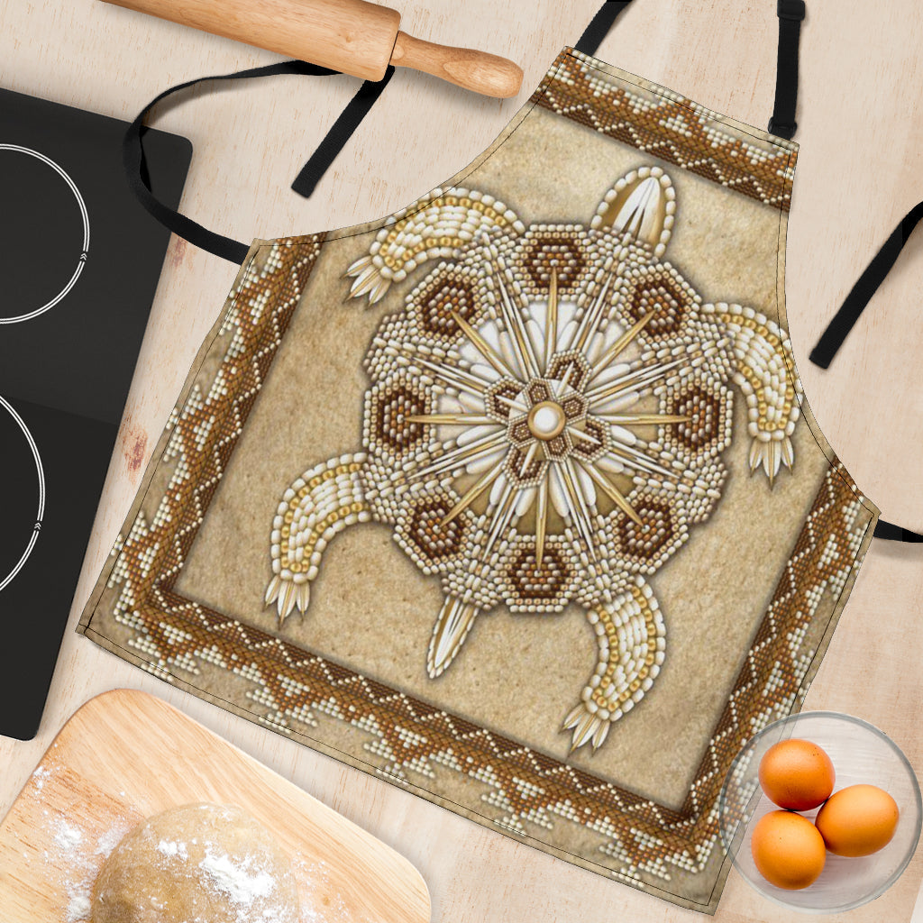 Close-up tan beaded apron panel with sunburst center, bead fringe, and geometric border