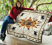 Chief and warriors quilt draped on patio chair; white background with starburst, horses and birds