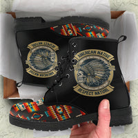 Black leather lace-up boot held in hand, colorful tribal print on side and toe