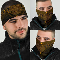 Viking neck gaiter on man, dark with large gold knot and sunburst marks