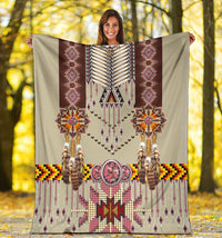 Beige breastplate blanket held outdoors, showing beaded jewelry motif and pink star