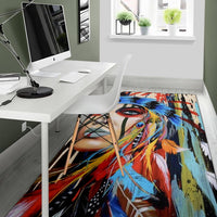 Multicolor area rug showing Native American woman portrait with bold blue and red accents