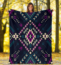 Dark color tribal geometric blanket held up; multicolor navy, teal, purple, cream