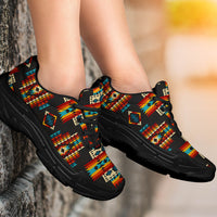 Pair of black chunky sneakers with Native American geometric pattern, lace-up