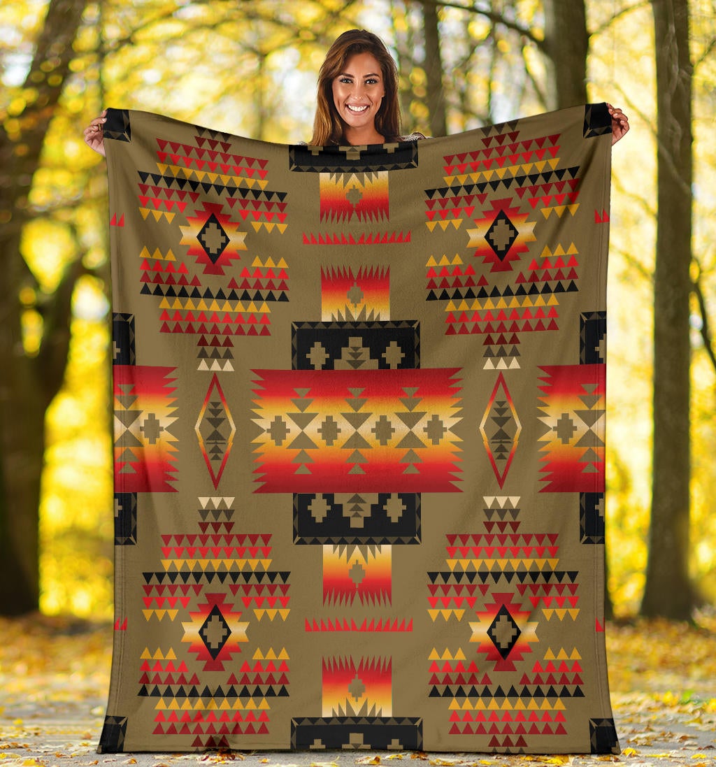 Multicolor tribal print blanket on dark brown background with geometric blocks and arrows