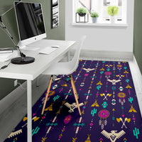 Thunderbird pattern area rug in dark blue with multicolor desert icons, office nook view