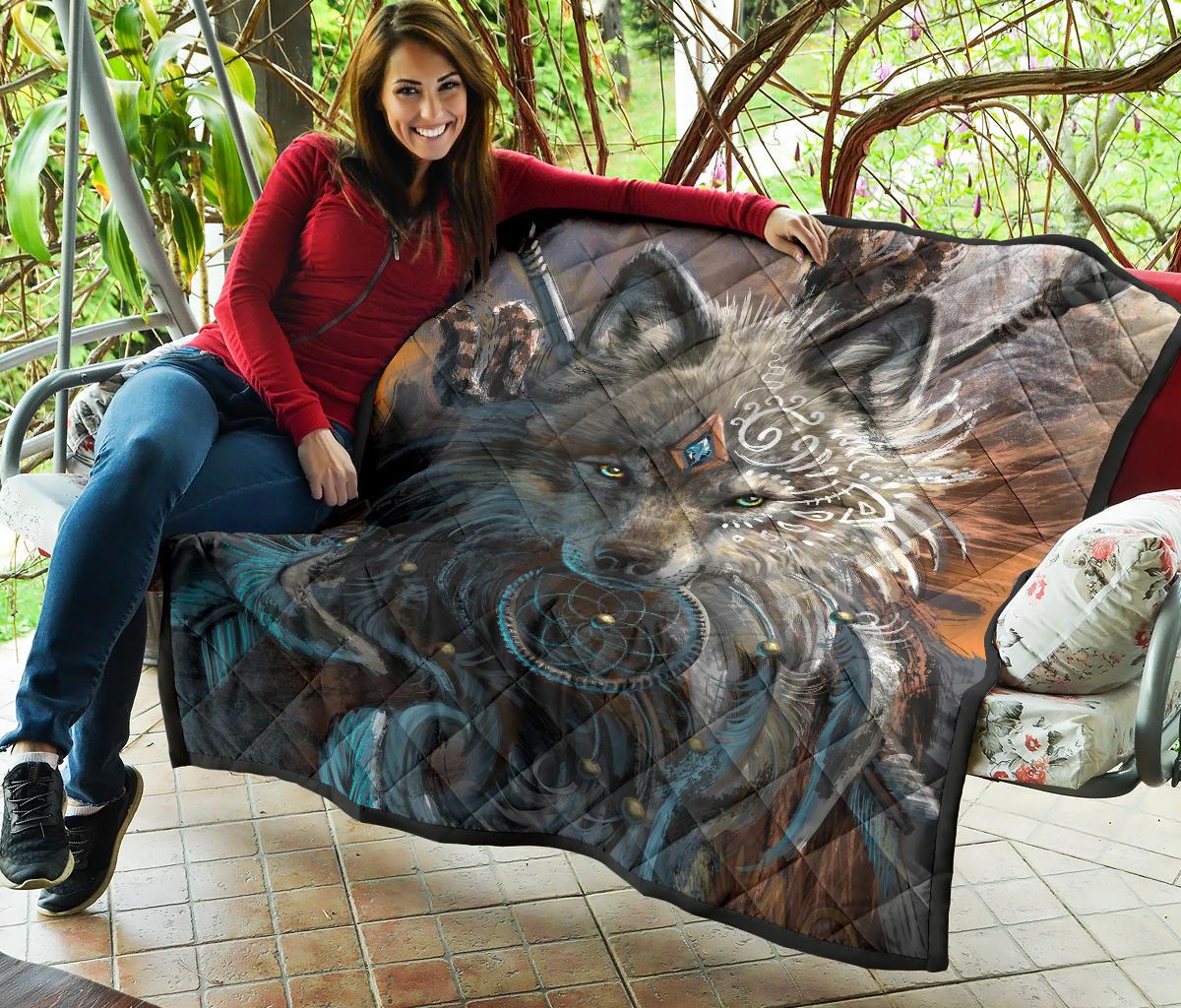 Quilt with close-up wolf design, blue swirls, and brown backdrop, framed by black trim