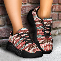 Tribal print chunky sneakers, black laces, thick black sole, angled side view