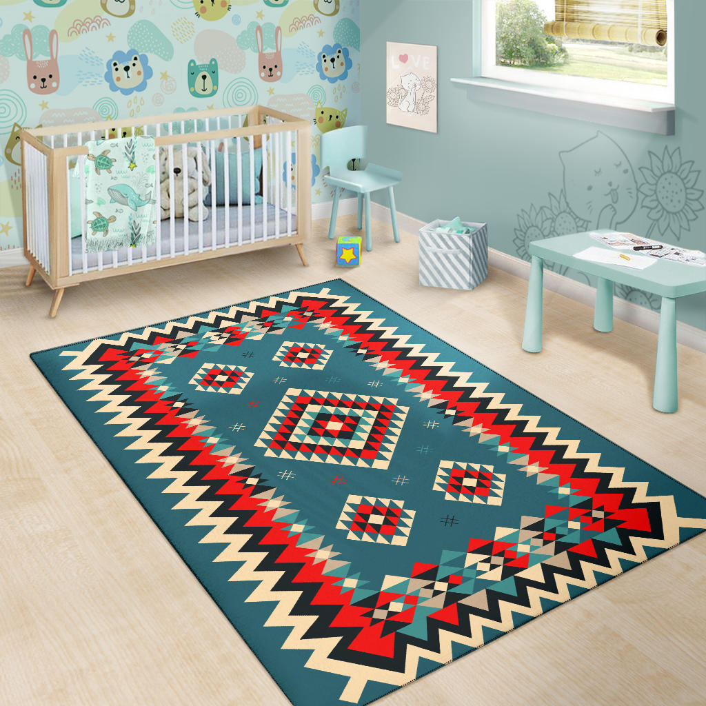 Teal geometric area rug with red, cream, and black diamond motifs and zigzag edge