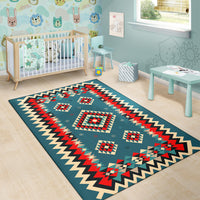 Teal geometric area rug with red, cream, and black diamond motifs and zigzag edge