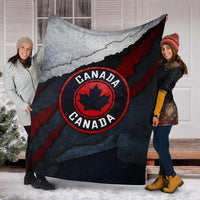 Canada blanket held by two people, grunge map and red circular maple-leaf emblem
