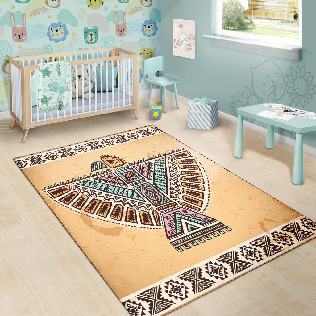 Beige kids area rug with native-style bird motif and black-and-white geometric border