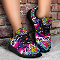 Worn multicolor tribal sport sneakers with black laces and black rubber sole, side view