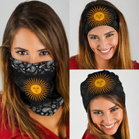 Black sun paisley neck gaiter with orange sun-face, worn over mouth