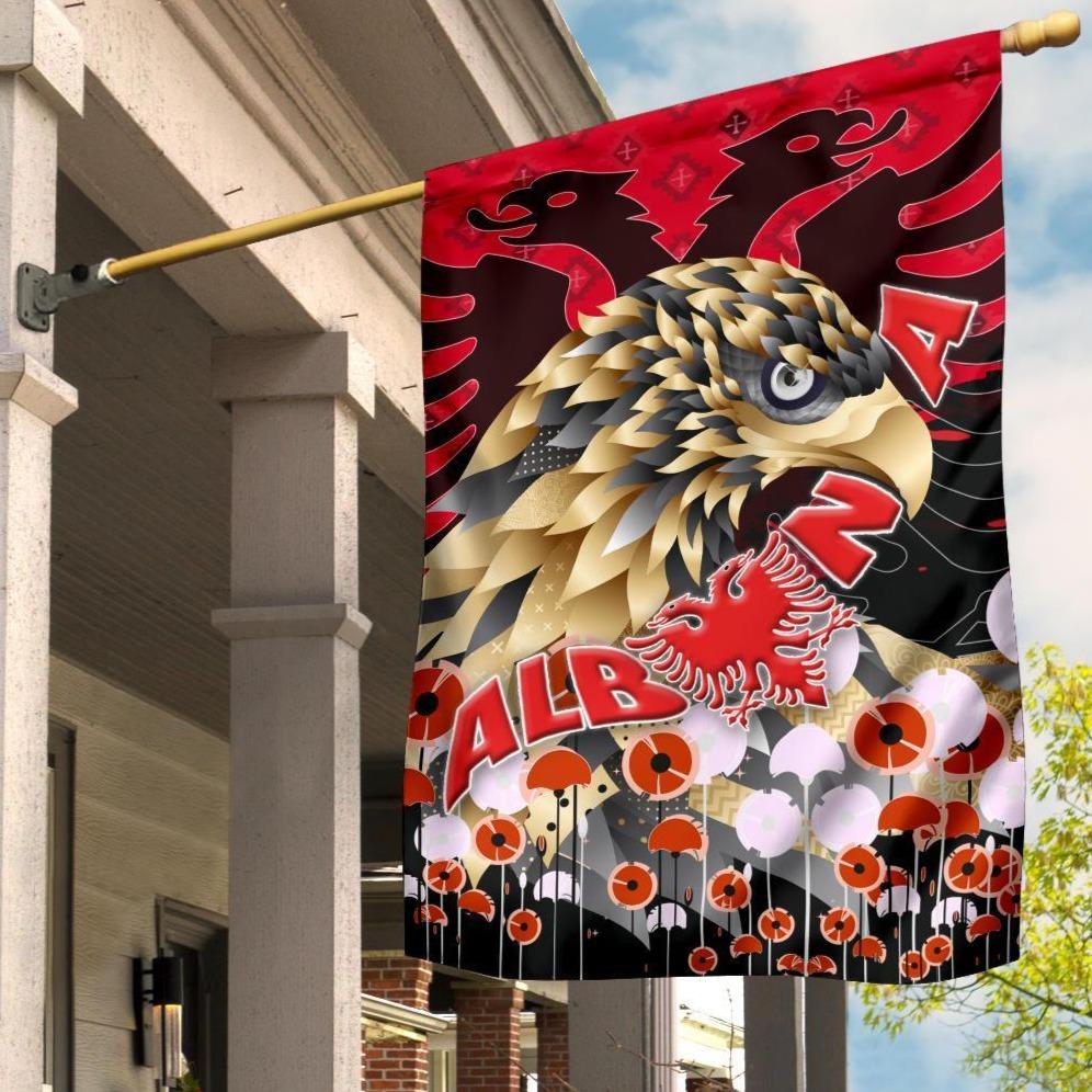 Red Albania flag with golden eagle graphic and lion face, on a hanging pole sleeve