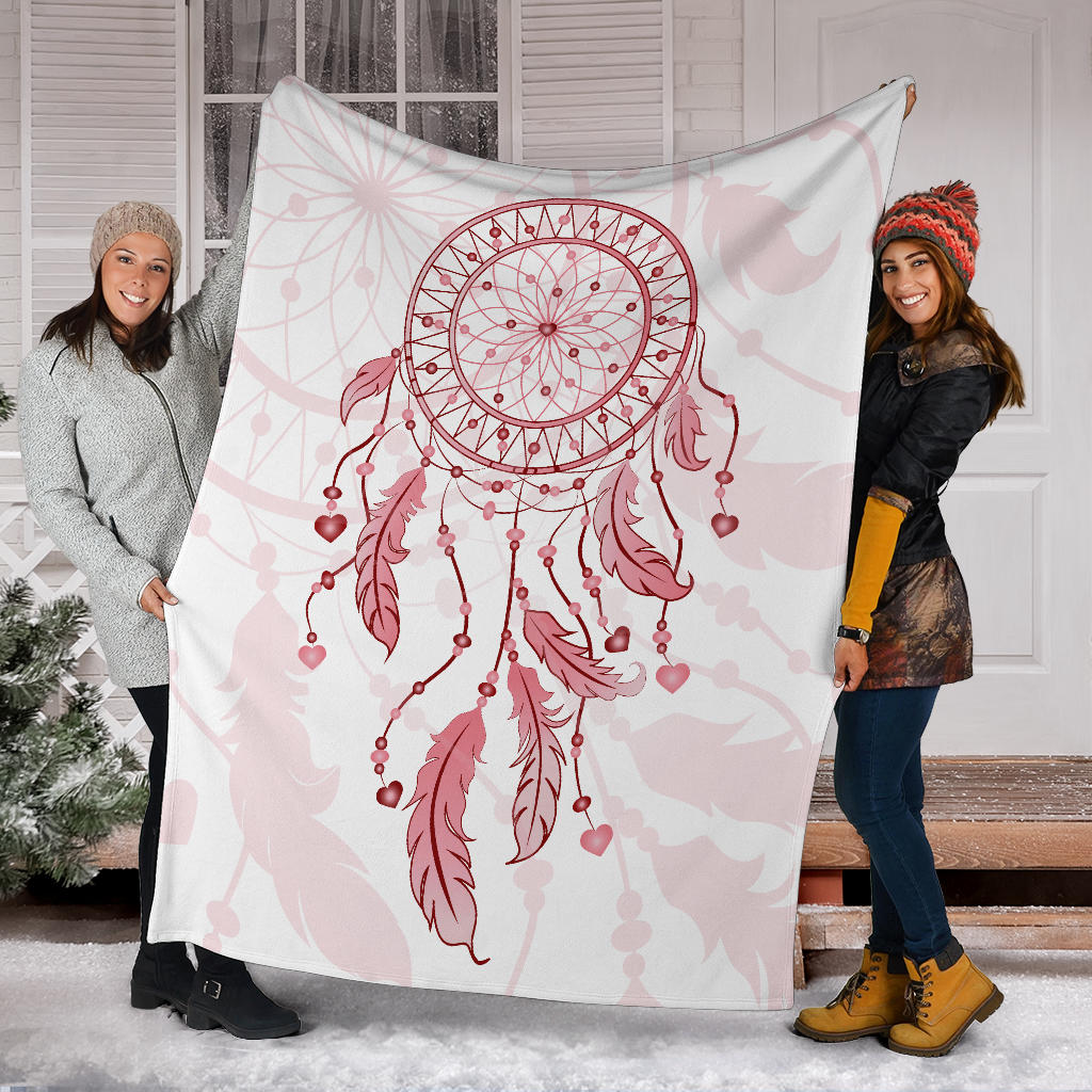 Pink dream catcher blanket wrapped on two people, showcasing central hoop and hanging hearts