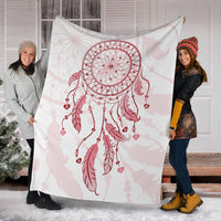 Pink dream catcher blanket wrapped on two people, showcasing central hoop and hanging hearts