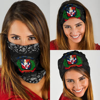 Two women wearing black paisley Dominican crest bandanas, headband and face coverage