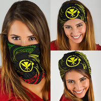 Black bandana with yellow tribal emblem and red-green swirls, worn by woman