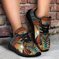 Southwest sport sneakers with turquoise beadwork and feather charm, tan geometric print, black sole