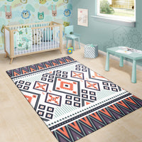 Colorful tribal area rug with white center, navy squares, orange-red motifs, and teal stripes