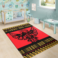 Red children’s rug style area rug with black bird design and yellow geometric border