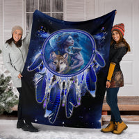 Blue dreamcatcher blanket stretched on front display, featuring girl-and-wolf central print
