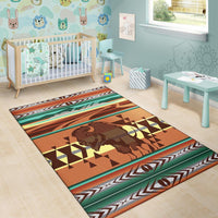 Multicolor bison area rug with geometric shapes and striped border in a nursery setting.