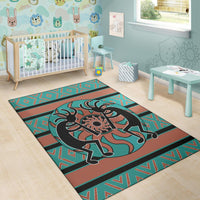 Kokopelli children’s room area rug in teal and rust with black figure and repeating geometric pattern