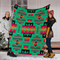 Light green multicolor geometric blanket held outdoors in winter snow