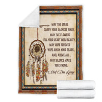 Cream Native-style blanket with dreamcatcher quote, plus folded white rolled throws