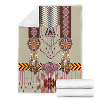 Folded breastplate blanket with geometric trim; includes two white matching towels
