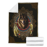 Black wolf blanket folded with white backing, showing dreamcatcher halo and feathered necklace