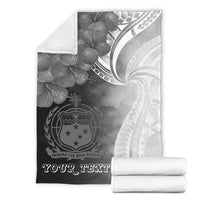 Folded premium blanket with black-and-white crest design and 'YOUR TEXT' lettering