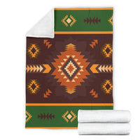 Geometric seamless blanket set with folded white backing, dark brown and green patterned front