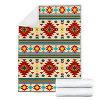 Folded southwest pattern blanket with coordinating rolled white bedding set