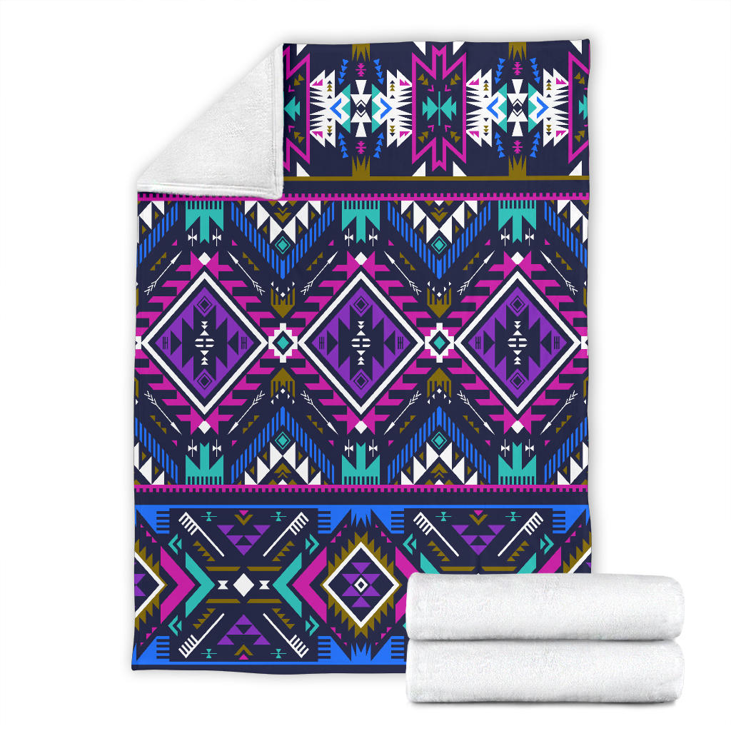 Purple tribal blanket rolled with two white towels, geometric diamonds and zigzag band