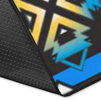 Close-up corner of colorful blue area rug with black edge and geometric pattern texture