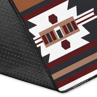 Corner close-up of rust, black, and white area rug with red geometric trim