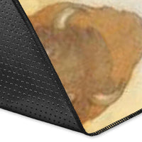 Rug corner close-up: dark border with stitched edge and orange-gray print