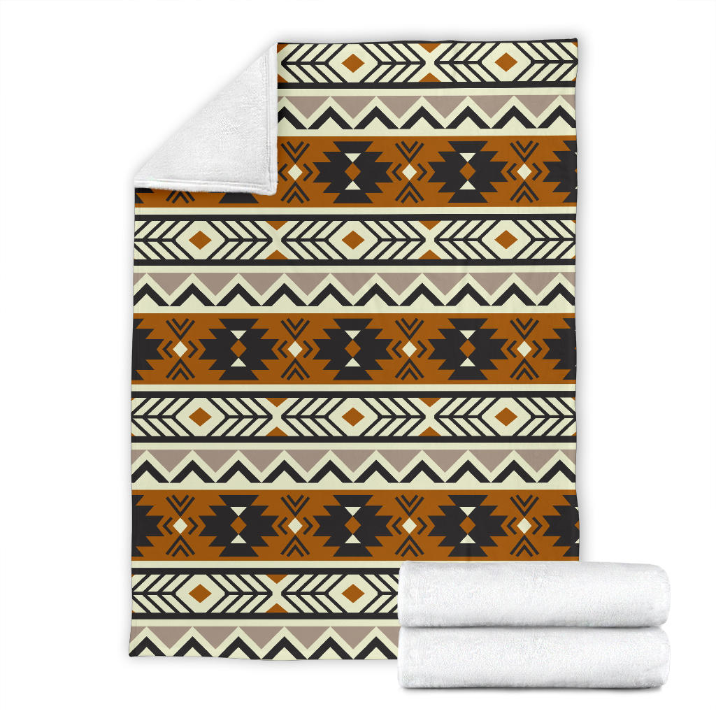 Folded seamless geometric blanket set with brown, black, white and tan pattern