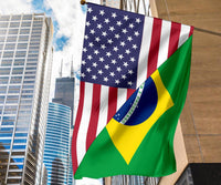 US and Brazil combo flag hanging from a pole, diagonal green panel with yellow crescent