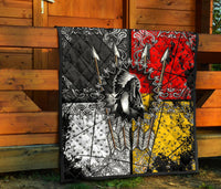 Chief Arrow quilt set against wooden wall: black red yellow white ornate arrow and feather design